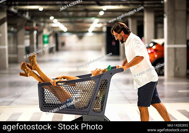 Underground parking, man, shopping cart, woman, push, fun