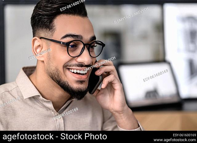 On the phone. A young good-looking businessman talking on the phone