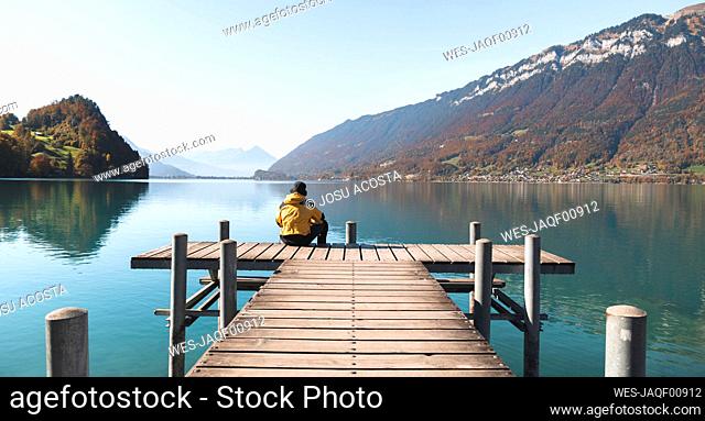Tourist looking at mountains on pier Interlaken, Switzerland