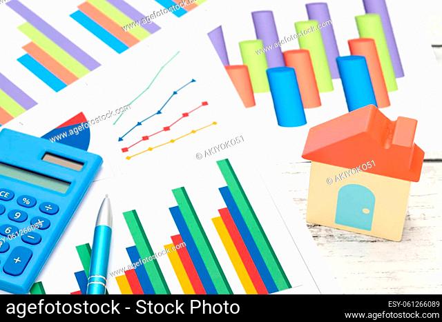toy house and color chart printed documents on the table