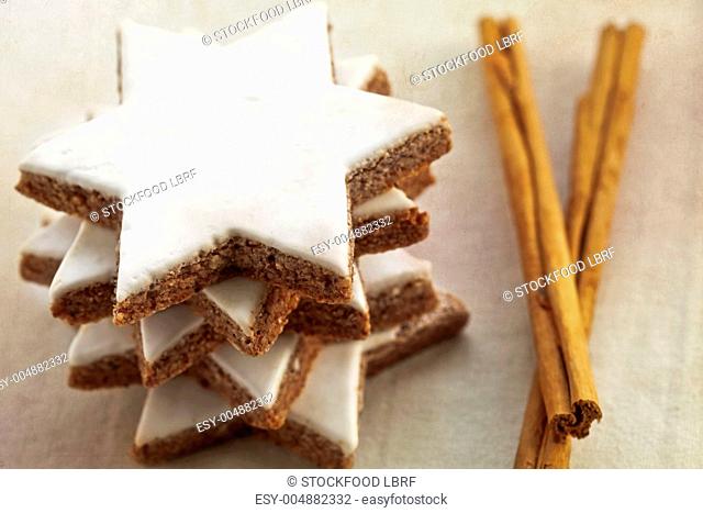 A stack of cinnamon stars with cinnamon sticks
