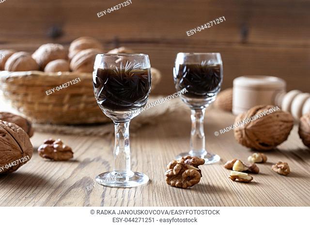 Homemade nut liqueur with walnuts on a table