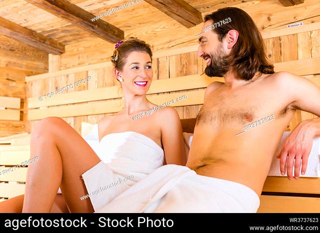 Couple sitting in wellness spa sauna