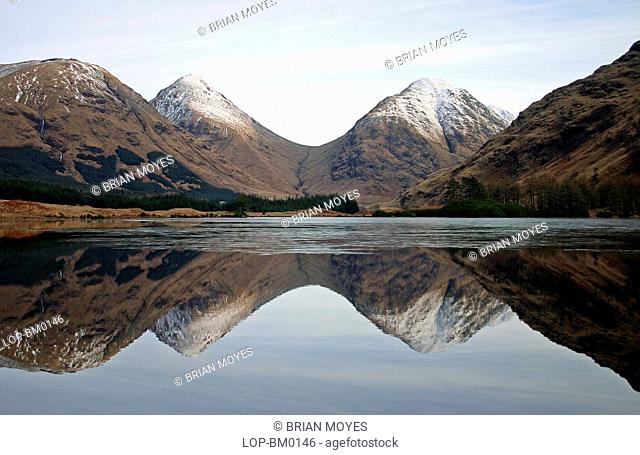 Scotland, Highland, Glen Coe, Snow capped mountain reflection with ice at Glen Etive
