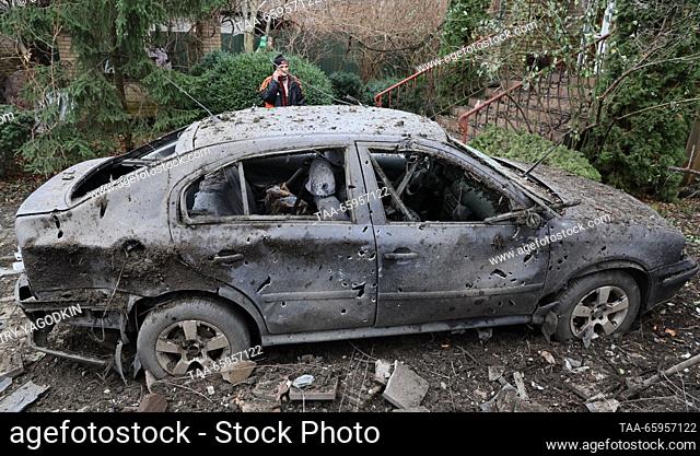 RUSSIA, DONETSK - DECEMBER 21, 2023: A man is seen by a car damaged in a shelling attack by the Ukrainian Armed Forces. Dmitry Yagodkin/TASS