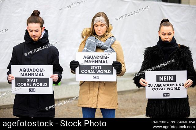 26 January 2023, Berlin: Activists hold placards at a protest by animal rights organization Peta against large aquariums and for a memorial for the dead fish in...