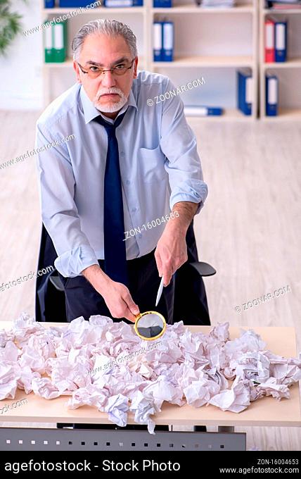 Businessman rejecting ideas with lots of papers