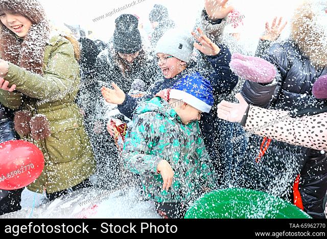 RUSSIA, MARIUPOL - DECEMBER 21, 2023: People are seen at the unveiling of a Christmas tree. Dmitry Yagodkin/TASS