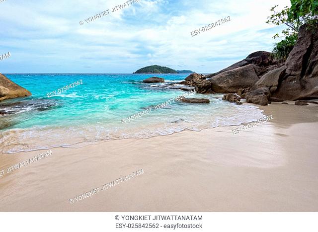 Beautiful landscape of blue sea sand and white waves on small beach near the rocks during summer at Koh Miang island in Mu Ko Similan National Park