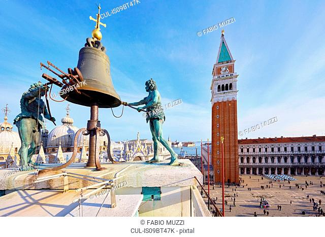 Bell on St Marks clock tower with view of St marks Square, Venice, Veneto, Italy
