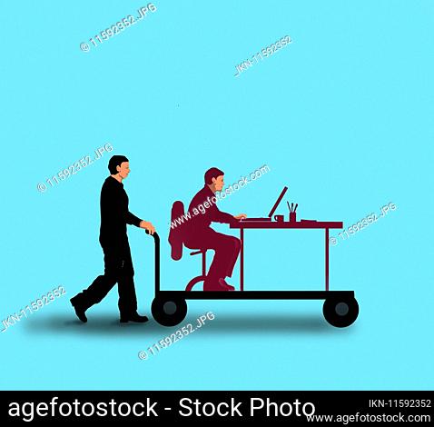 Office worker at desk being moved on trolley