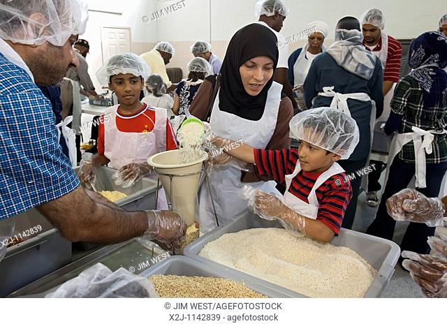 Detroit, Michigan - Volunteers working through the Islamic Relief charity prepare meal packages for Detroit area families in need  The packages of rice, soy