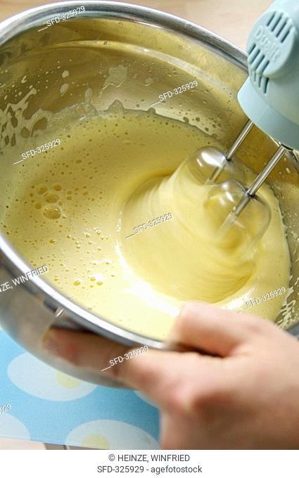 Beating lemon & egg yolk mixture with electric hand mixer