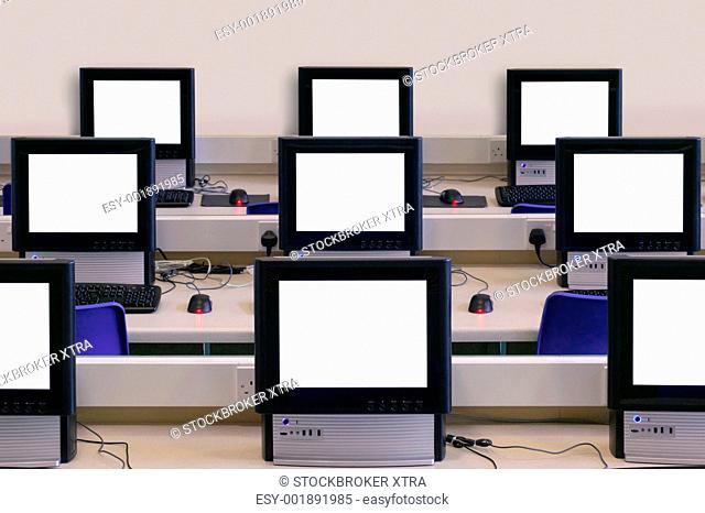 IT classroom with multiple blank computer screens to add your own message or image