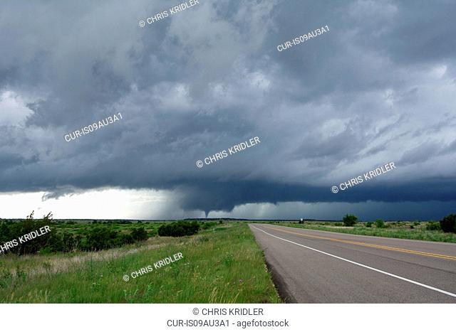 Diminishing perspective of road and tornado storm clouds, Guthrie, Texas, USA