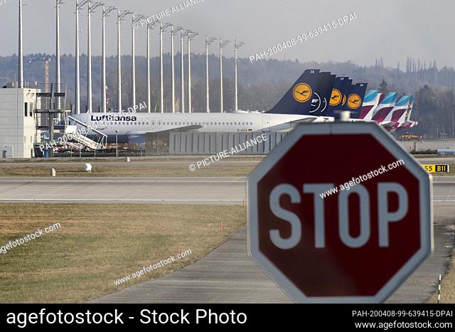 08 April 2020, Bavaria, Munich: Decommissioned aircraft belonging to Lufthansa (front) and the Lufthansa subsidiary Eurowings stand on the apron at Munich...