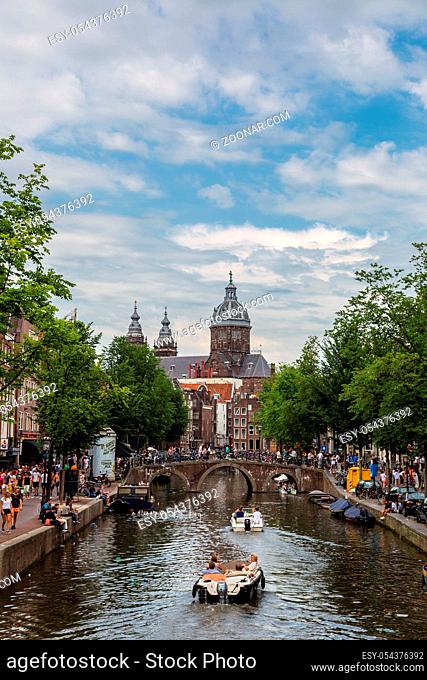AMSTERDAM, NETHERLANDS - AUGUST 19: Canal and St. Nicolas Church in Amsterdam. Amsterdam is the capital and most populous city of the Netherlands on August 19