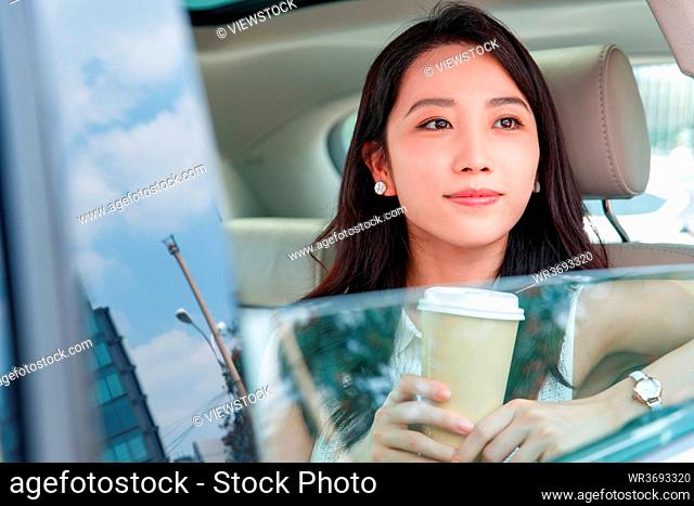 Car in the beautiful young woman