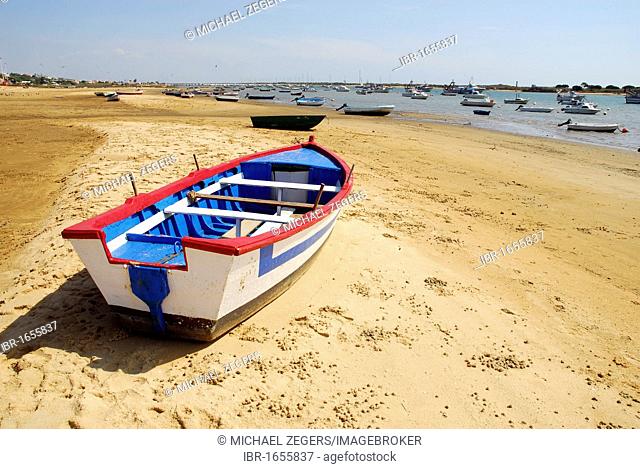 Boat at the Rio Piedras river, low tide at the beach in El Rompido, at back Nueva Umbria, Cartaya, Costa de la Luz, Huelva region, Andalucia, Spain, Europe