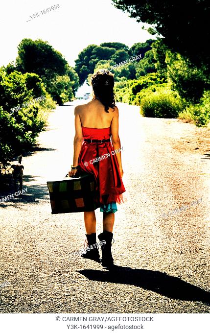 Fashion picture of the back of a girl in a red dress, from a whole fashion series