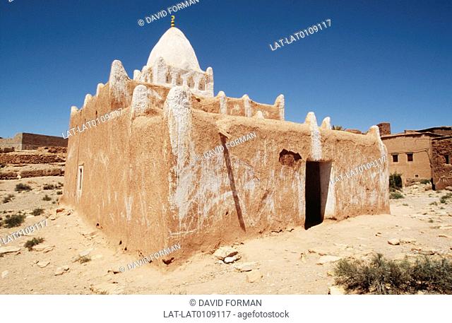 In Erfoud there is a small house constructed in the local style of mud and adobe walls, with a terraced roof and a large white dome shape