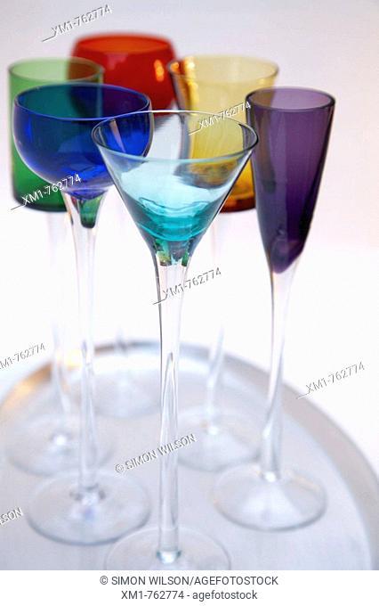 Silver tray with tall coloured liquer glasses
