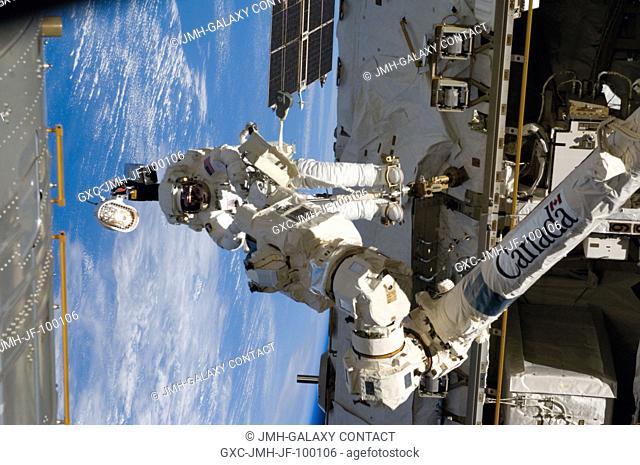 Astronaut Richard Arnold, STS-119 mission specialist, participates in the mission's third scheduled session of extravehicular activity (EVA) as construction and...
