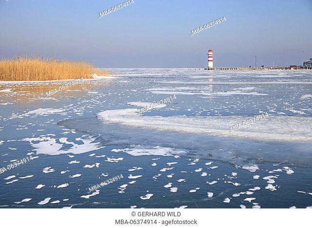 icebound Neusiedlersee (lake), reed and lighthouse close Podersdorf am See, Burgenland, Austria