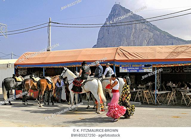 flamenco dancers and horseriders celebrating the annual fair in front of the Rock of Gibraltar, Spain, La Linea De La Concepcion