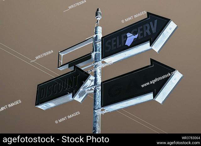 Self Serve sign, three arrows on an elevated roadside sign