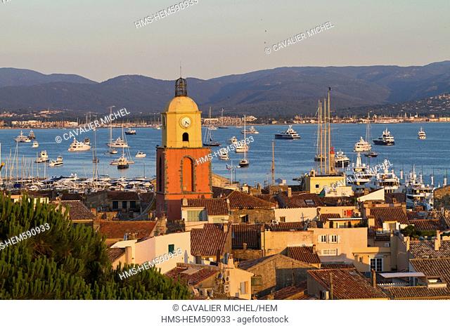 France, Var, Saint Tropez, the clock of the bell tower of the parish church built in 1634 with ochre color, seen from the Citadel