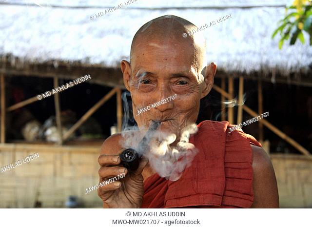 An elderly man from ethnic community smokes a pipe Tidu in Bandarban, Bangladesh December 2, 2009