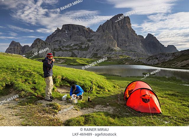Hikers at Neunerkofel, red tent, Boedenalpe, Bodenseen lake, South Tyrol, Dolomites, Italy