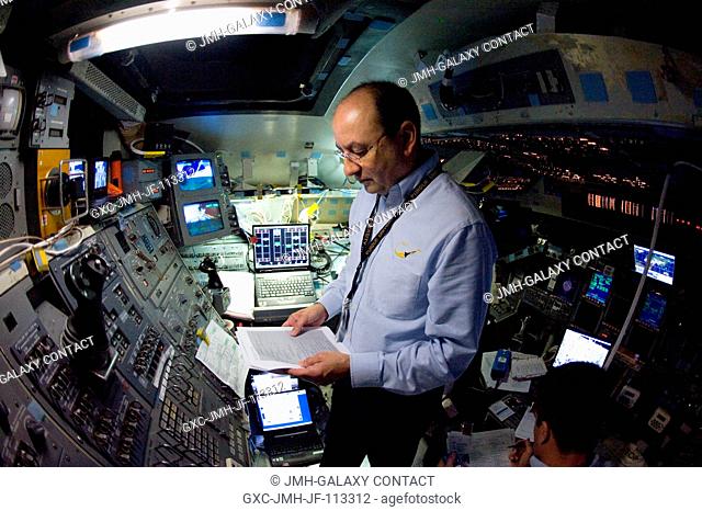 Astronaut Mark Polansky, STS-127 commander, looks over a checklist during a training session in the Jake Garn Simulation and Training Facility at NASA's Johnson...