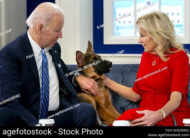United States President Joe Biden, left, and first lady Dr. Jill Biden, right, pet their dog, a German Shepherd puppy named 'Commander'