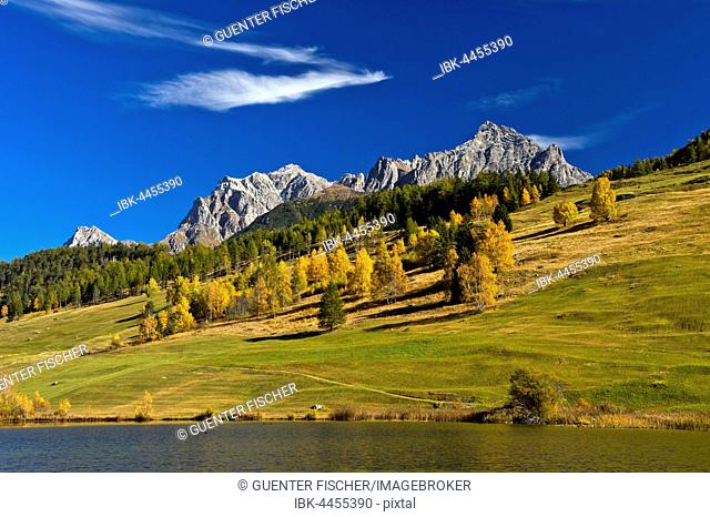 Lai da Tarasp, lake with mountain landscape in autumn, Tarasp, Engadin, Grisons, Switzerland