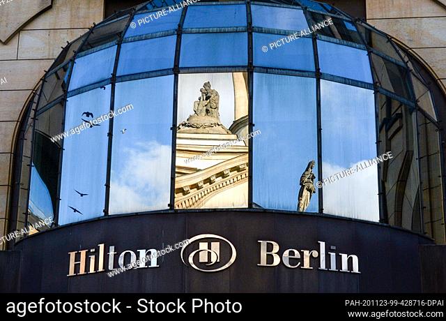 05 November 2020, Berlin: The Hilton lettering on the building of the hotel in Mohrenstraße on Gendarmenmarkt. The German cathedral is reflected in the window...