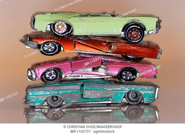 Stacked broken miniature cars, symbolic picture for scrapping premium
