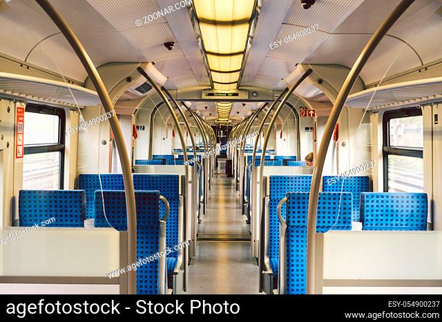 Inside The Wagon Train Germany, Dusseldorf. Empty train interior. interior view of corridor inside passenger trains with blue fabric seats of German railway...