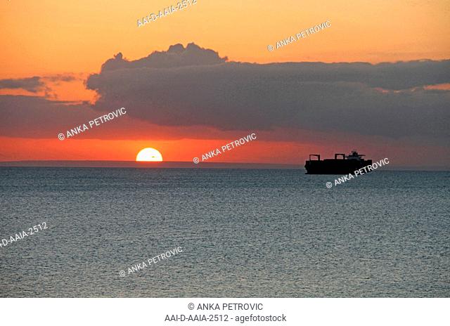 Fishing trawler and sunset horizon with clouds off the coast of Zanzibar, Unguja Island, Tanzania