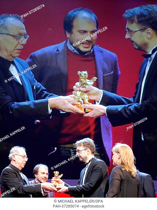 Director Calin Peter Netzer (2nd R) receives the Golden Bear for Best Film for the movie 'Child's Pose' ('Pozitia Copilului') from festival director Dieter...