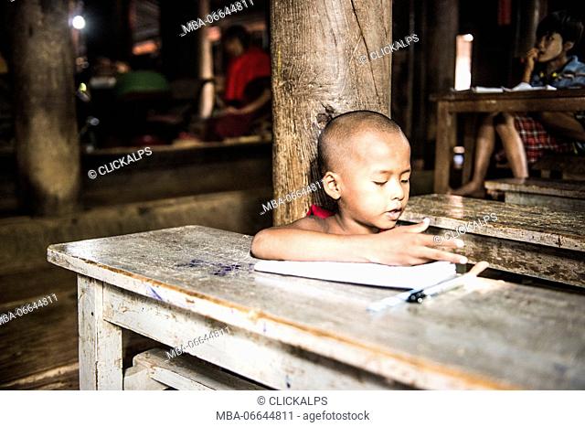 Inwa, Mandalay region, Myanmar (Burma). A young monk studying in the Bagaya Kyaung monastery