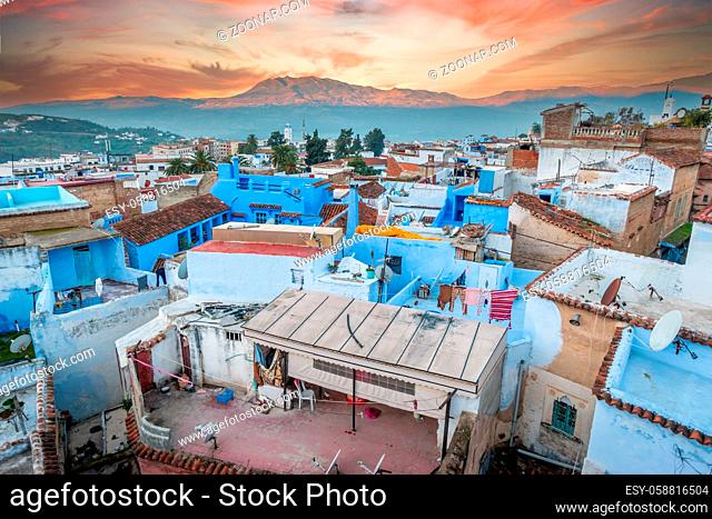 Amazing sunrise over rooftops of Chefchaouen's Blue City, Medina, Morocco where residents hang their laundry