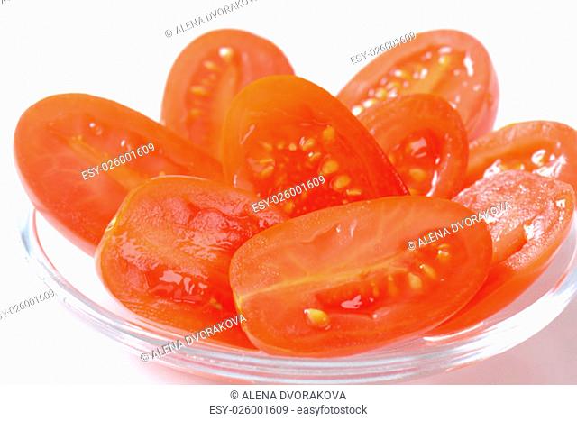 Halved fresh oval-shaped red tomatoes