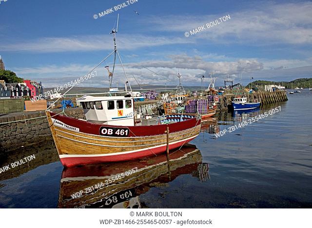 Small fishing boats moored Tobermory harbour Isle of Mull Scotland