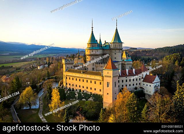 Side view of Bojnice castle with one wall bathed in lovely morning light. Medieval heritage site with towers illuminated by golden light in the morning