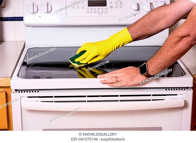 Cleaning a top of a oven range to clean it