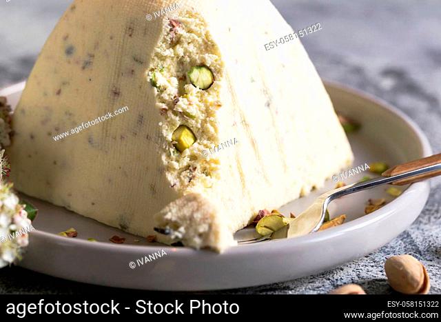 Paskha and kulich with pistachios. Traditional Russian Orthodox Easter Quark Dessert Curd. Easter food background. Traditional cottage cheese cake
