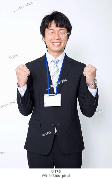 Smiling Businessman Clenching His Fists