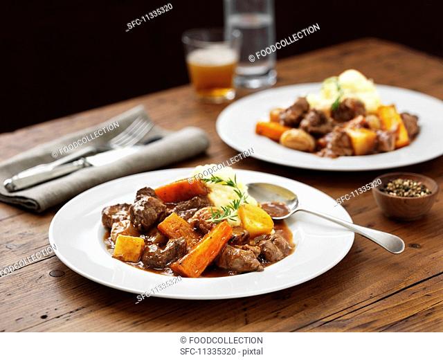 Lamb stew with mashed potatoes, carrots and beer
